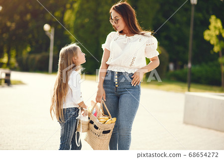 Mother with daughter playing in a summer paek Mother with daughter playing in a summer paek 68654272