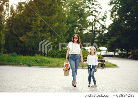 Mother with daughter playing in a summer paek Mother with daughter playing in a summer paek 68654282