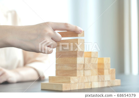 Hand holding blocks wood game, Concept Risk of management and strategy plan Hand holding blocks wood game, Concept Risk of management and strategy plan 68654379