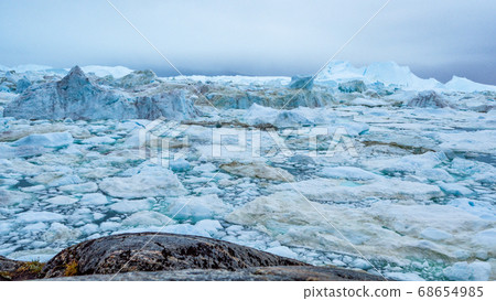 Icebergs from melting glacier in icefjord - Global Warming and Climate Change Icebergs from melting glacier in icefjord - Global Warming and Climate Change 68654985