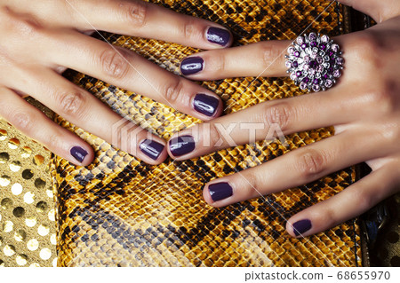 pretty fingers of african american woman holding money closeup with purse, luxury jewellery on python clutch, cash for gifts pretty fingers of african american woman holding money closeup with purse, luxury jewellery on python clutch, cash for gifts 68655970