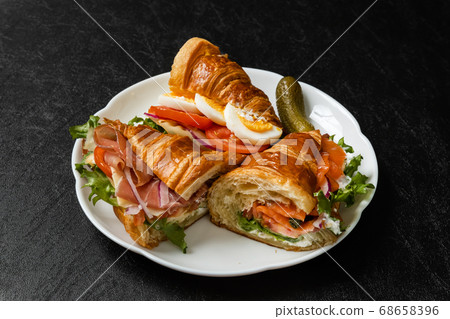 Croissant ham sandwich with cheese 68658396