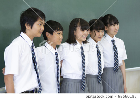 Junior high school students standing in front of the blackboard Junior high school students standing in front of the blackboard 68660185