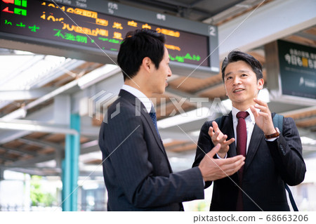 Businessmen talking at the station platform "Keio Electric Railway Co., Ltd." Businessmen talking at the station platform "Keio Electric Railway Co., Ltd." 68663206