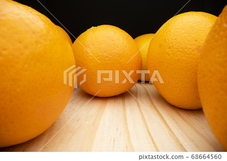 Macro shot of oranges on wooden table Macro shot of oranges on wooden table 68664560