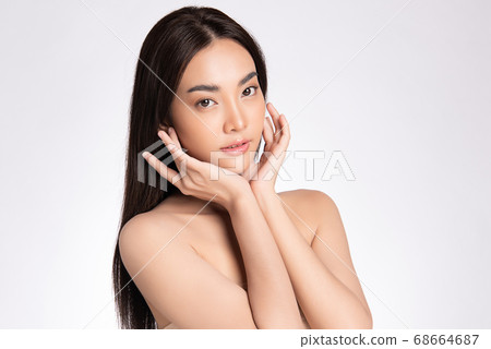 Beautiful Young asian Woman with Clean Fresh Skin, on white background, Face care, Facial treatment. Beautiful Young asian Woman with Clean Fresh Skin, on white background, Face care, Facial treatment. 68664687