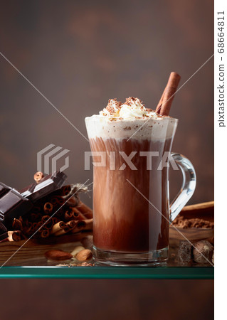 Cocoa with cream, cinnamon, chocolate pieces and 68664811