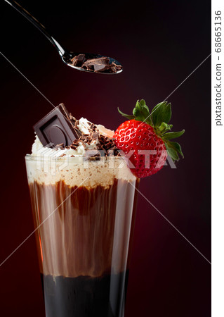 Chocolate drink with whipped cream, strawberry and 68665136