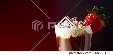 Chocolate drink with whipped cream, strawberry and 68665137