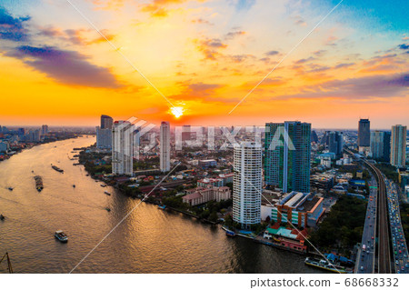 Sunset over the city building with transport road Sunset over the city building with transport road 68668332
