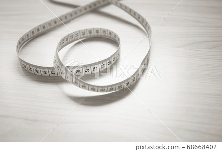 Round and round heart-shaped tape measure sepia tone Round and round heart-shaped tape measure sepia tone 68668402