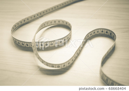 Tape measure in sepia tone 68668404