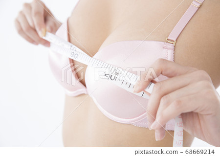 A woman measuring bust size 68669214