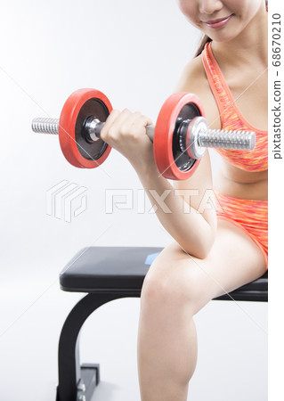 Women doing weight training 68670210