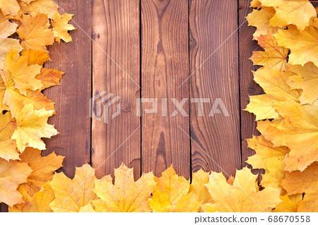 Autumn leaves frame on wooden background top view Autumn leaves frame on wooden background top view 68670558