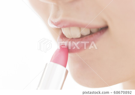 A woman applying lipstick 68670892