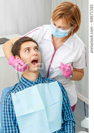 Handsome young man in visit at the dental office. Handsome young man in visit at the dental office. 68671385
