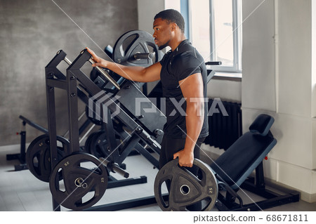 A handsome black man is engaged in a gym A handsome black man is engaged in a gym 68671811