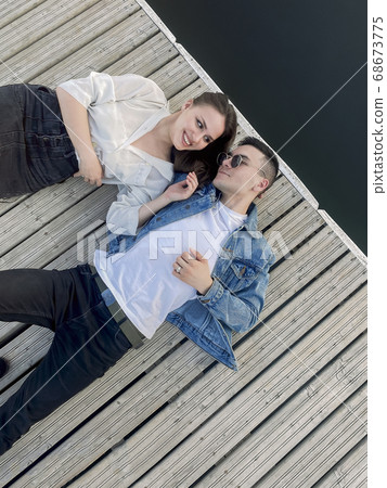 Young couple relaxing on pier in summer 68673775