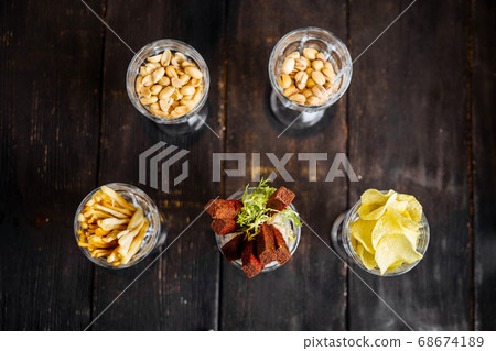 Assorted variety of beer bar snacks in glasses Assorted variety of beer bar snacks in glasses 68674189