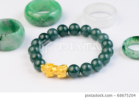 Green bracelet jade with jadeite ring on background Green bracelet jade with jadeite ring on background 68675204