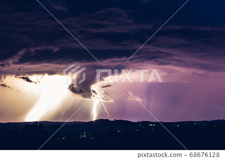 Night landscape on a background of thunderstorms. 68676128