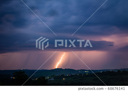 Night landscape on a background of thunderstorms. 68676141