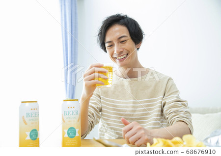 Man drinking beer alone in the room Man drinking beer alone in the room 68676910