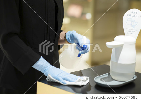 Woman disinfecting 68677685