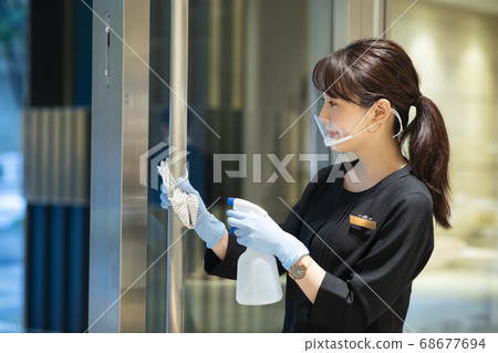 Woman disinfecting 68677694