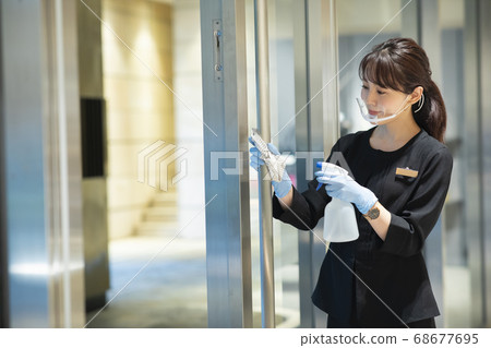 Woman disinfecting 68677695