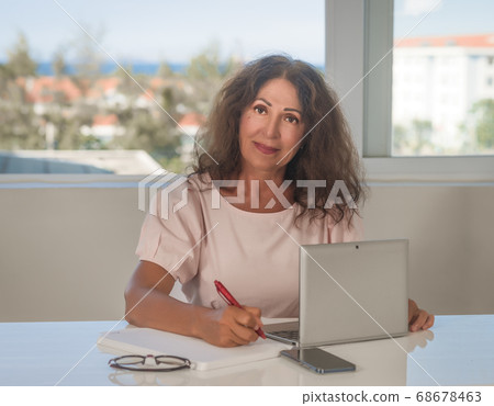 Portrait of a beautiful senior woman working at Portrait of a beautiful senior woman working at 68678463