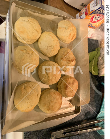 Pan full of golden brown Homemade biscuit on stove top  68678734