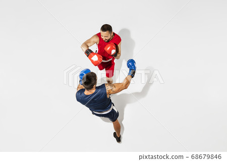 Two professional boxers boxing isolated on white studio background, action, top view Two professional boxers boxing isolated on white studio background, action, top view 68679846