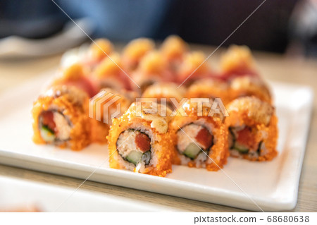 Sushi roll of maguro tuna topped with salmon roe at luxury high end japanese restaurant. Plate of sushis. 68680638