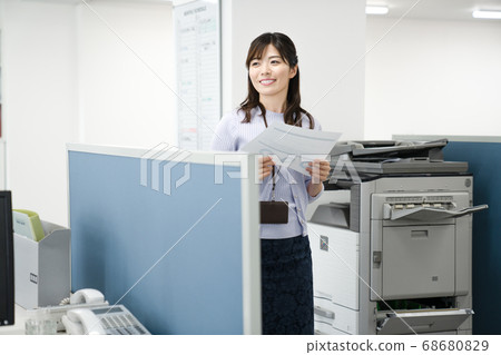 Female employee giving a copy Female employee giving a copy 68680829