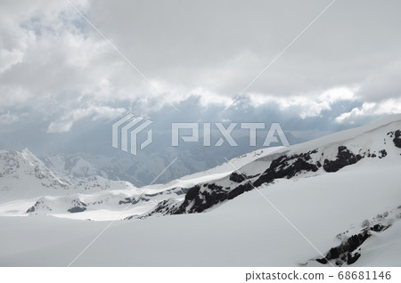 Evening high mountain scenery snow-covered rocky steep mountains of the main mountain range of the northern Caucasus 68681146