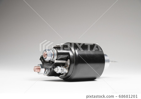 Starter solenoid for car on gray background. Auto parts 68681201