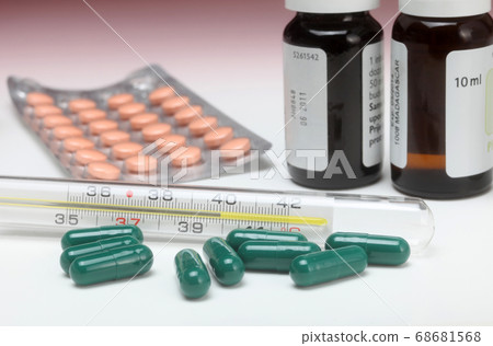 Close-up medical thermometer and pills Close-up medical thermometer and pills 68681568