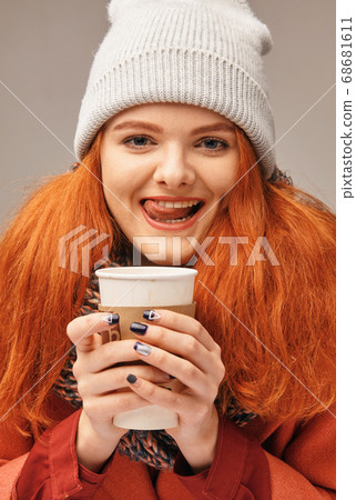 Woman holding hot coffee on winter day Woman holding hot coffee on winter day 68681611