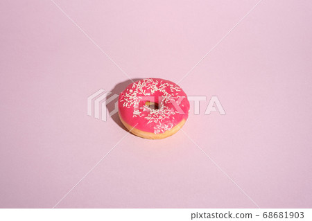 Pink donut with sprinkles, sweet glazed dessert food on pink minimal background 68681903