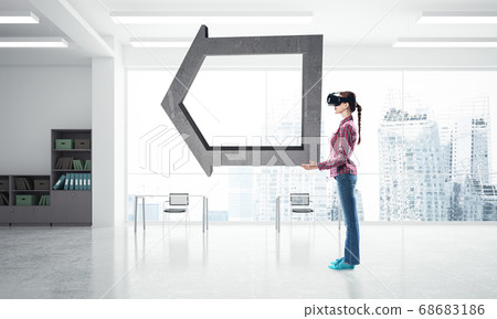 Girl in virtual reality mask experiencing virtual technology world. Mixed media 68683186