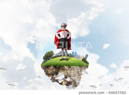 Girl power concept with cute kid guardian against cityscape background Girl power concept with cute kid guardian against cityscape background 68683568