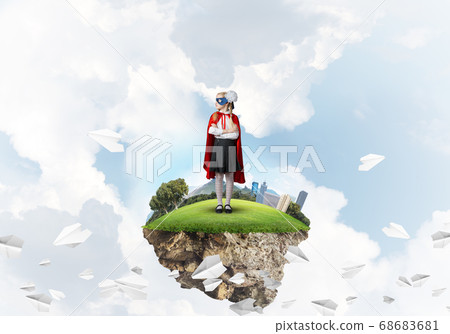 Girl power concept with cute kid guardian against cityscape background 68683681