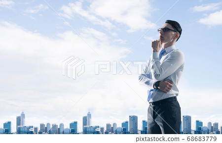 Concept of business success and control with confident boss against cityscape background 68683779