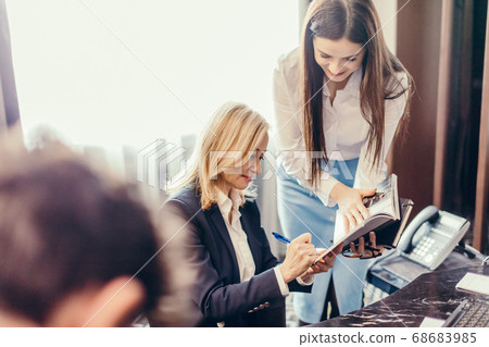 Female Boss working with assistant at the office 68683985