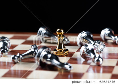 Gold pawn chess defeats silver figures on board. 68684216