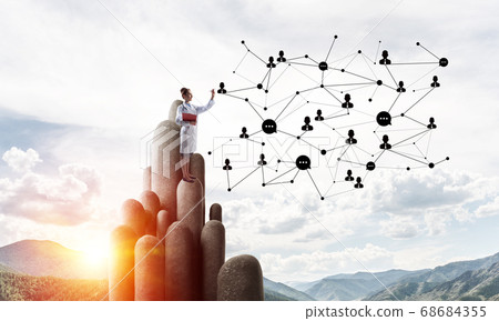 Medicine specialist or practitioner outdoors standing on top Medicine specialist or practitioner outdoors standing on top 68684355