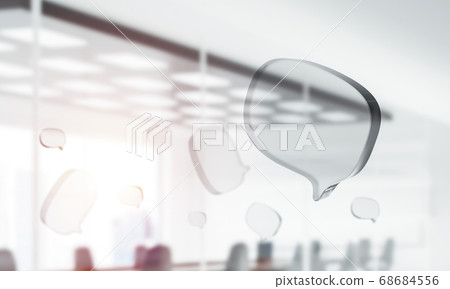 Concept of communication by glass empty chat icon on office background. Mixed media Concept of communication by glass empty chat icon on office background. Mixed media 68684556