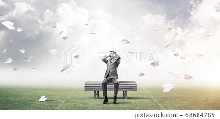 Young man in suit in park dont want to hear anything Young man in suit in park dont want to hear anything 68684785